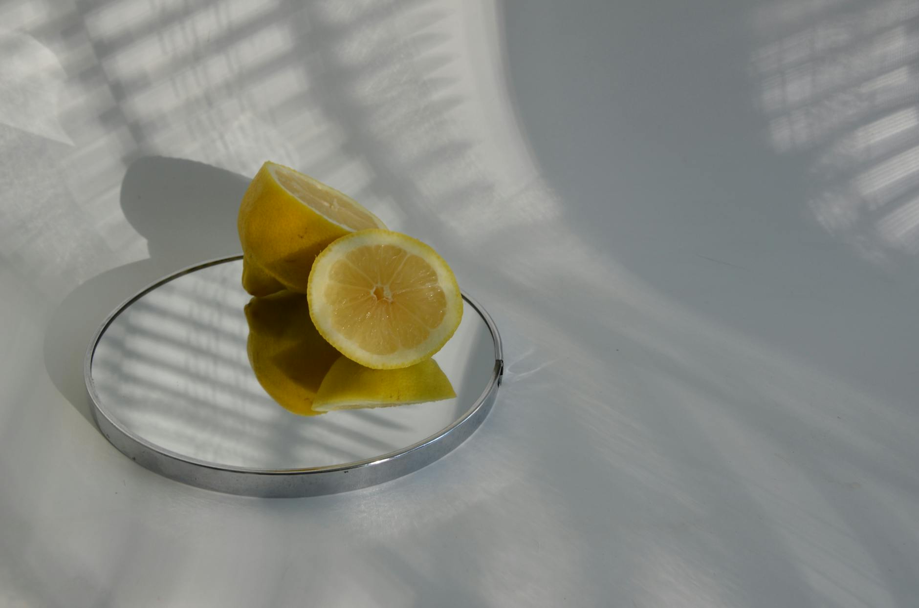 Yellow silicone vibrator surrounded by fresh fruit on a bright yellow background, symbolizing sensuality and natural pleasure.