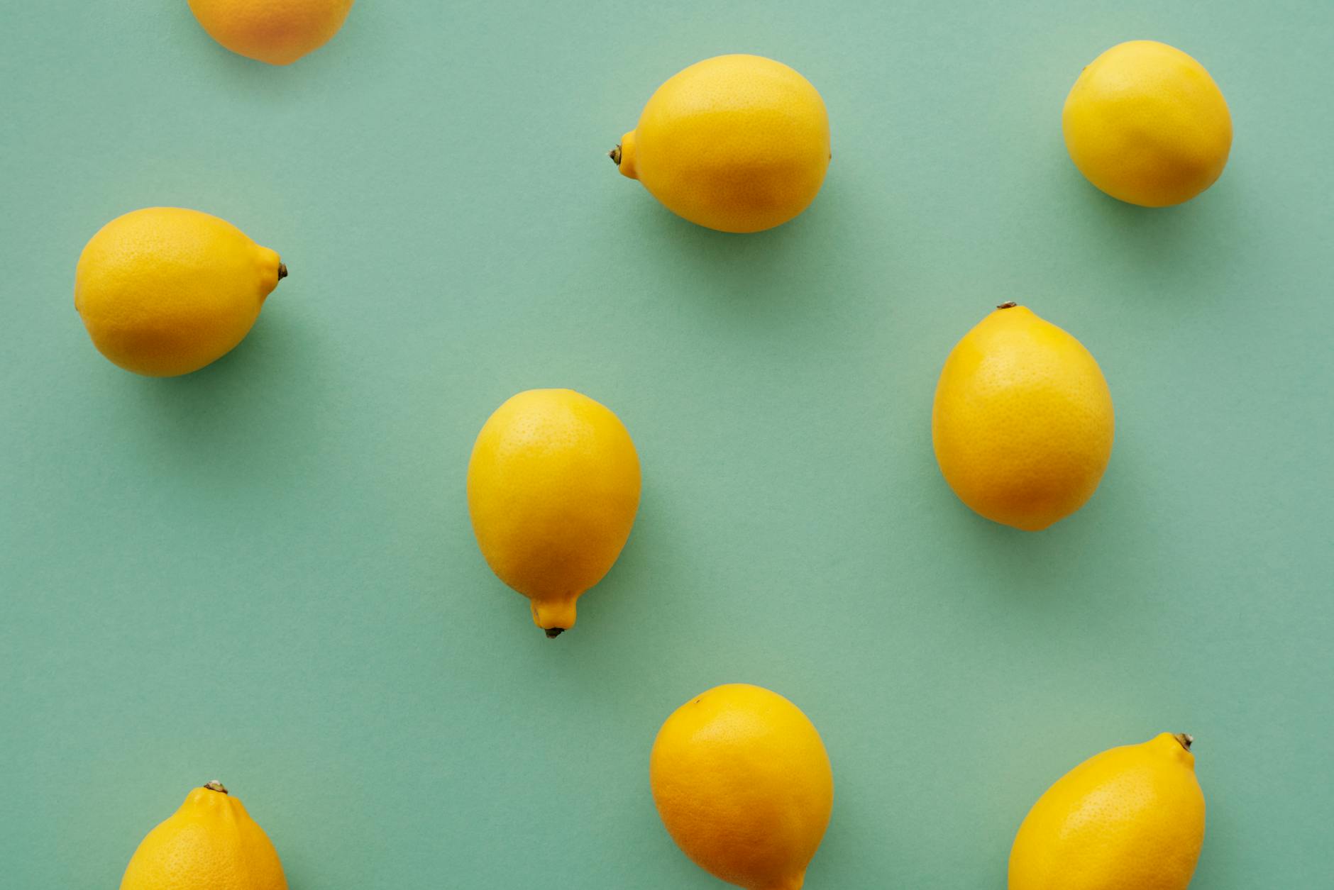 Bright yellow lemons on a soft green background, symbolizing gentle recovery and fresh sensation.