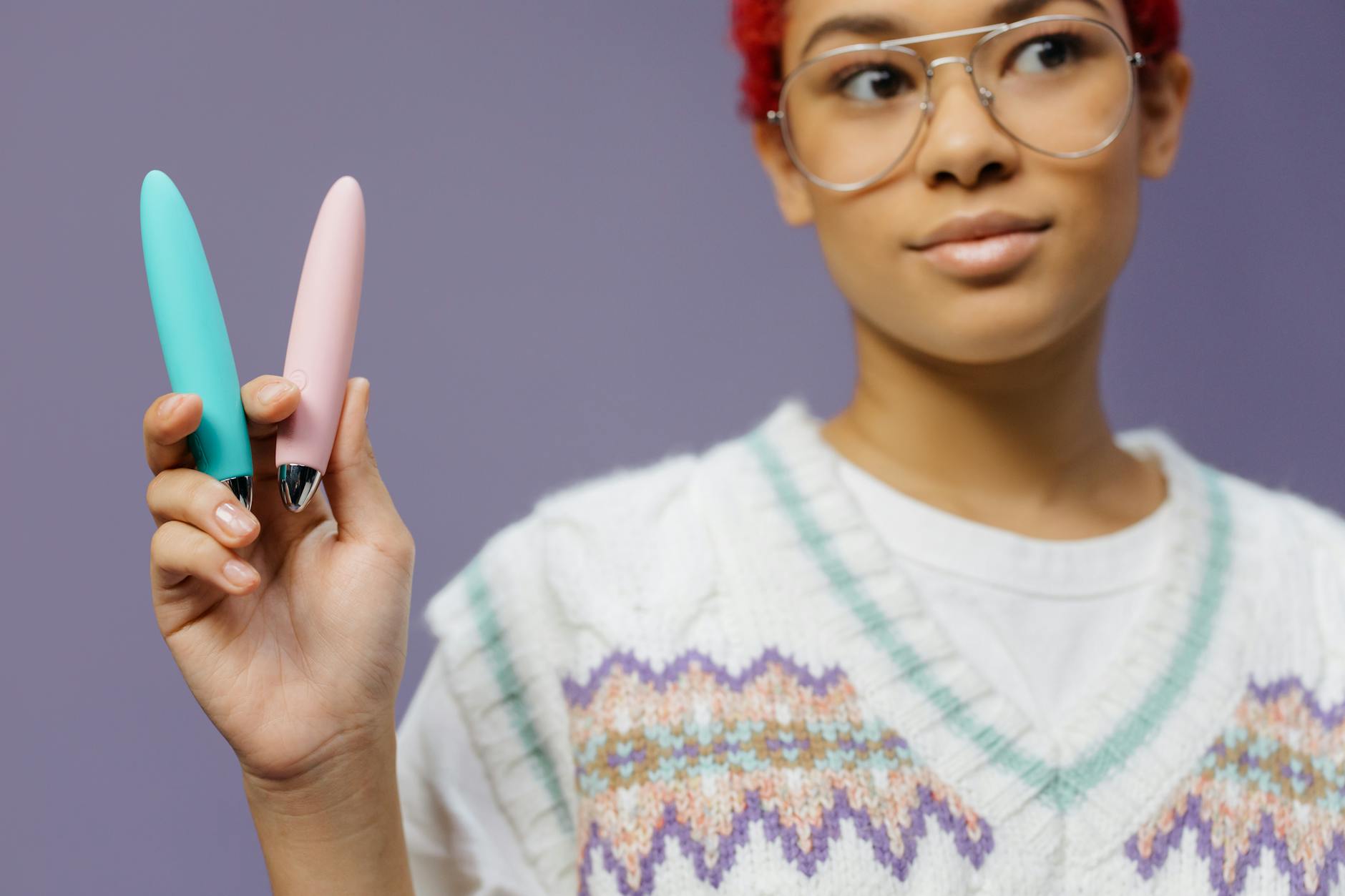 Woman holding two vibrators, exploring different techniques for extended pleasure