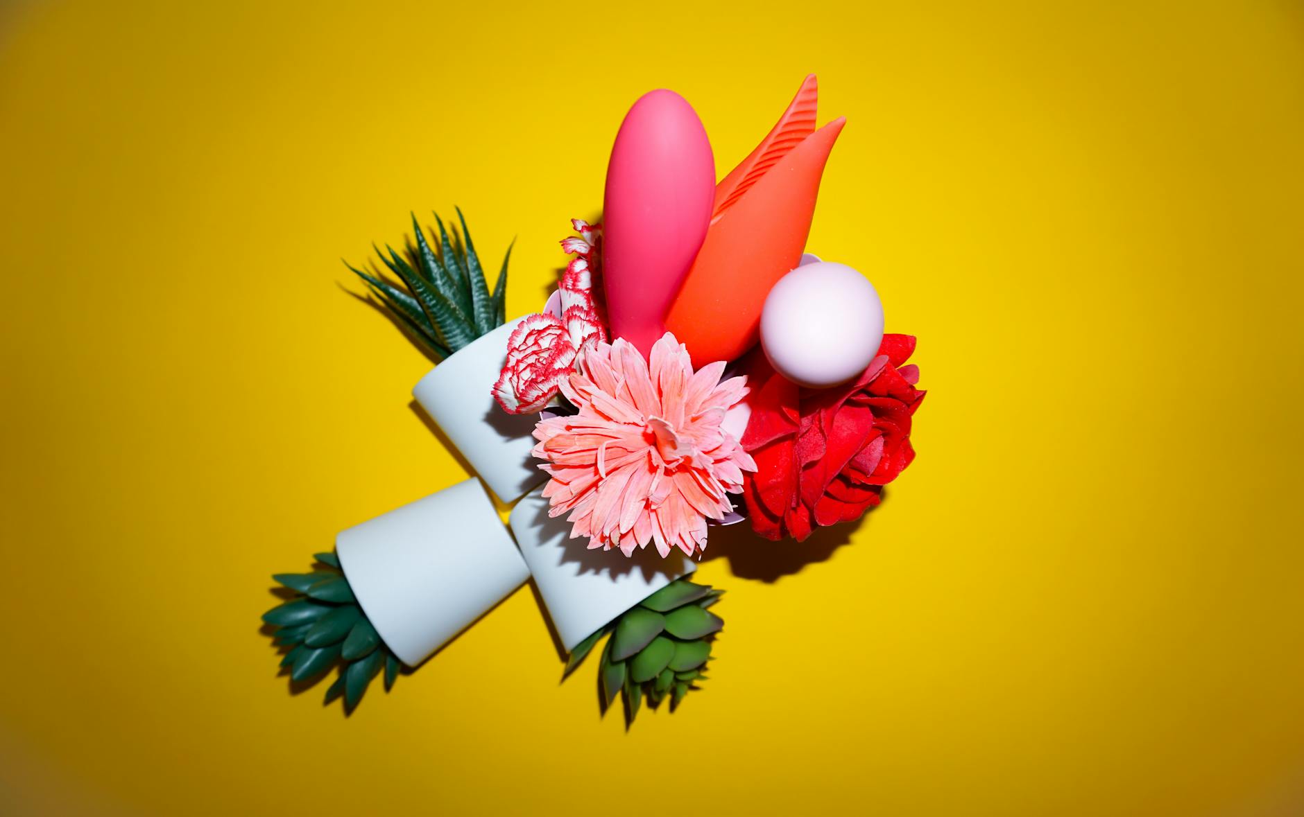 Three colorful vibrators on white fabric, demonstrating design options for clitoral stimulation